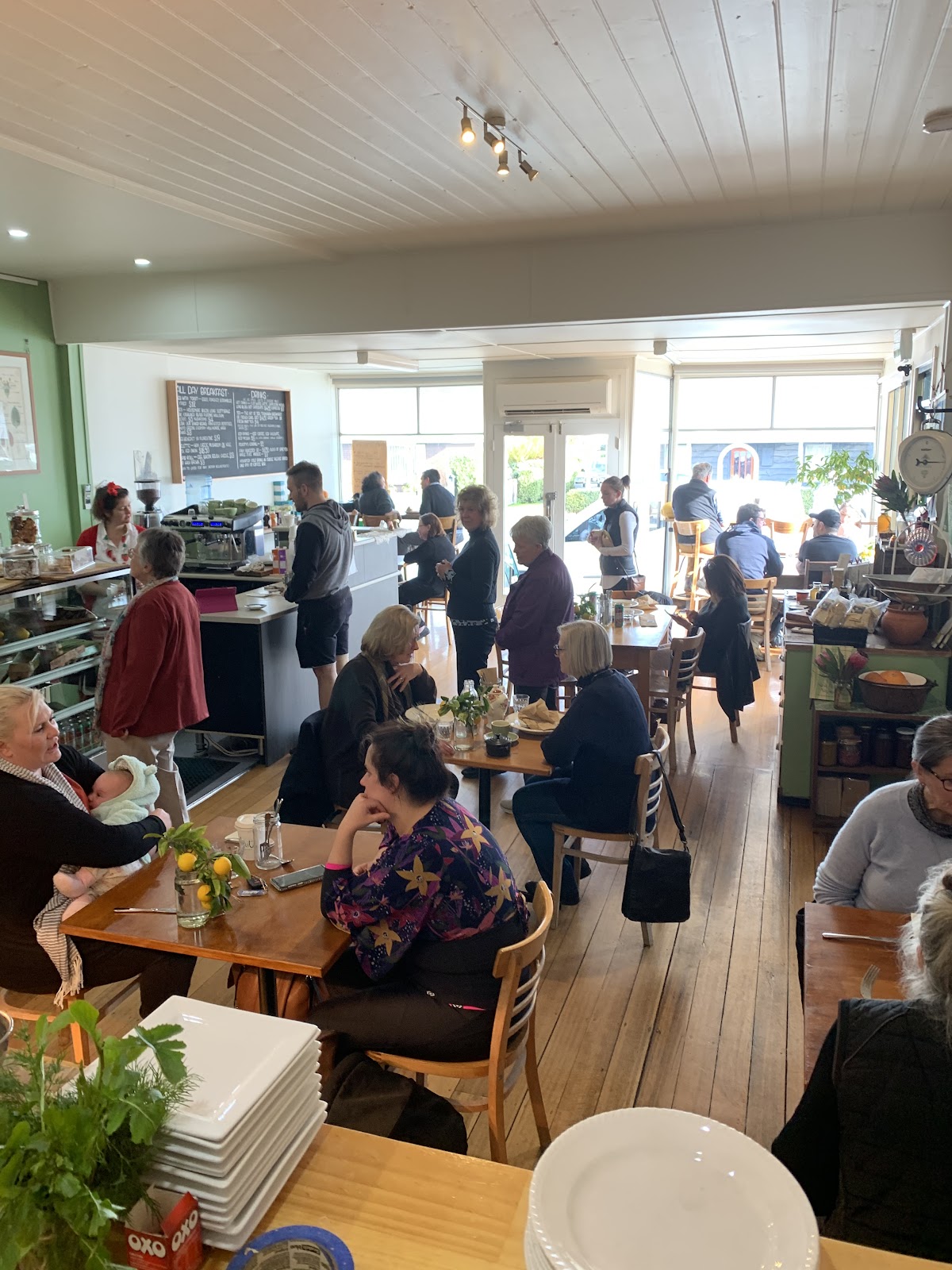 Inside Feast on a busy morning, timber floors and tables full of diners