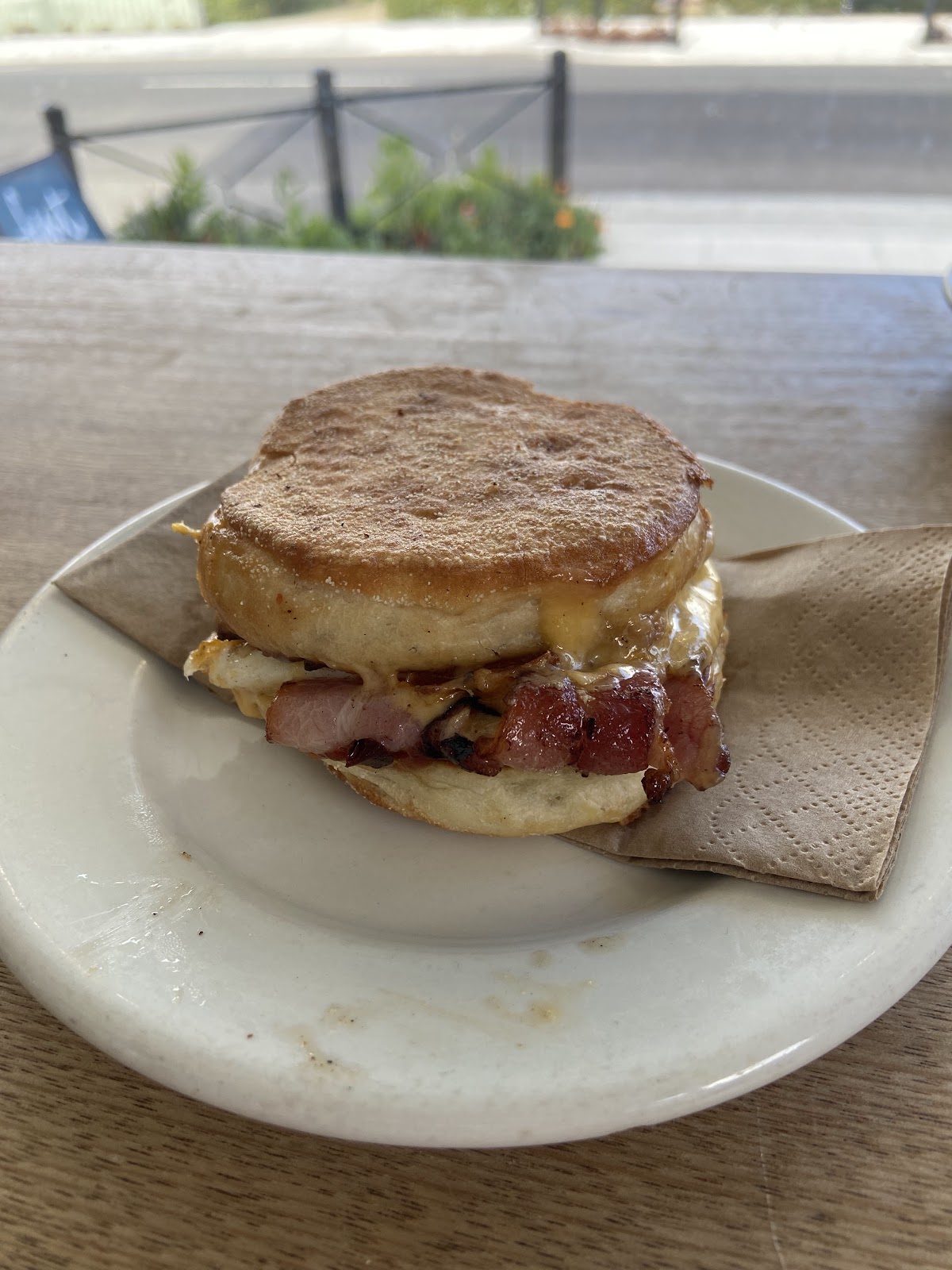 A bacon and egg muffin by the front window