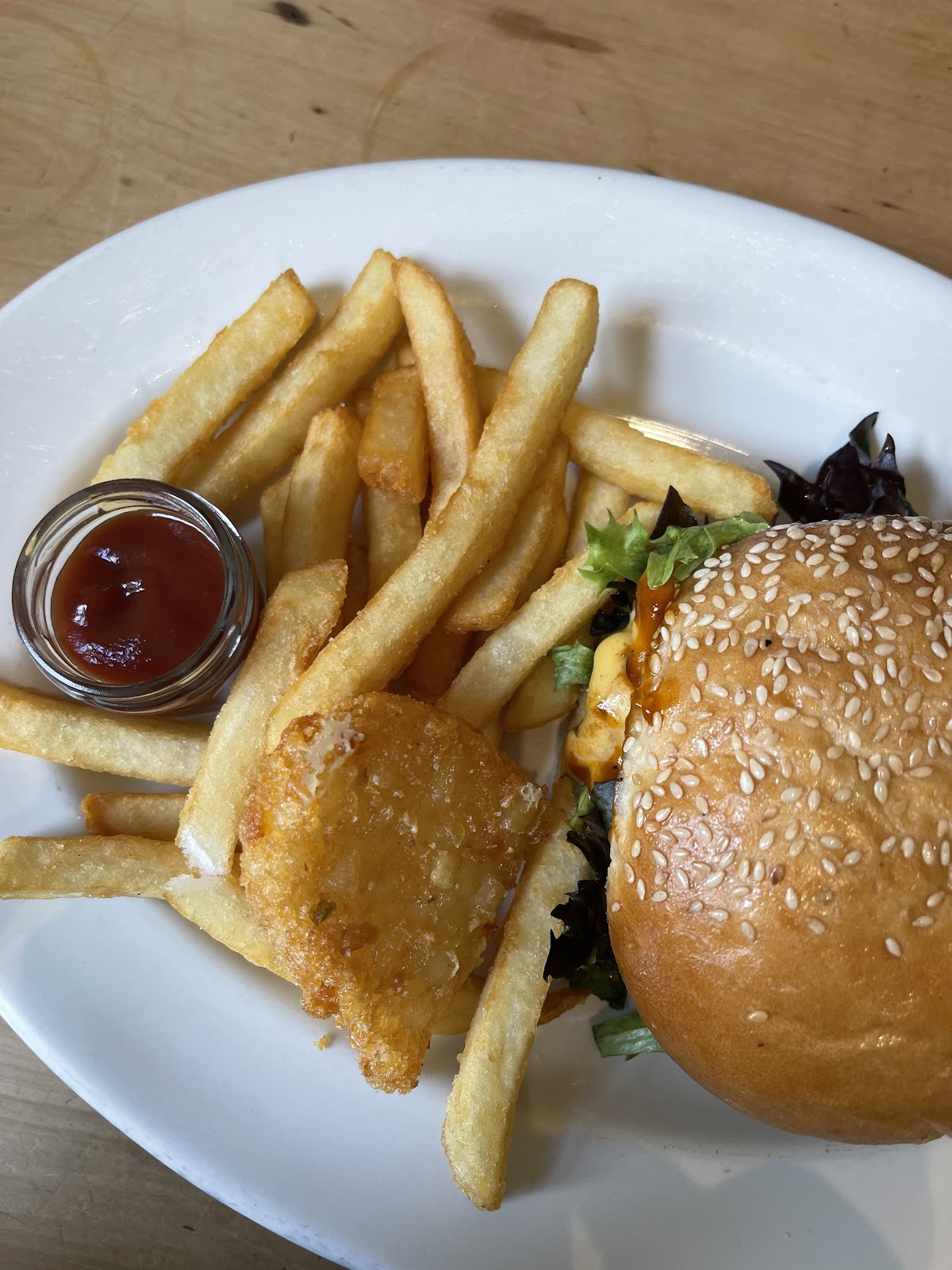 A burger with chips and a hash brown